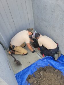 slab-leak-repair-warm-spot-orange-county Professional Plumbing technicians excavating to repair a slab leak at an Orange County home