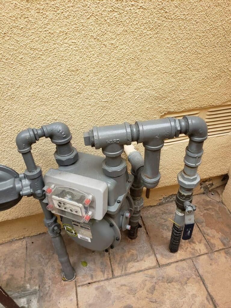 gas-installation-service-residential-gas-meter-orange-county Gas installation service Orange County: residential natural gas meter and supply piping at the side of a home