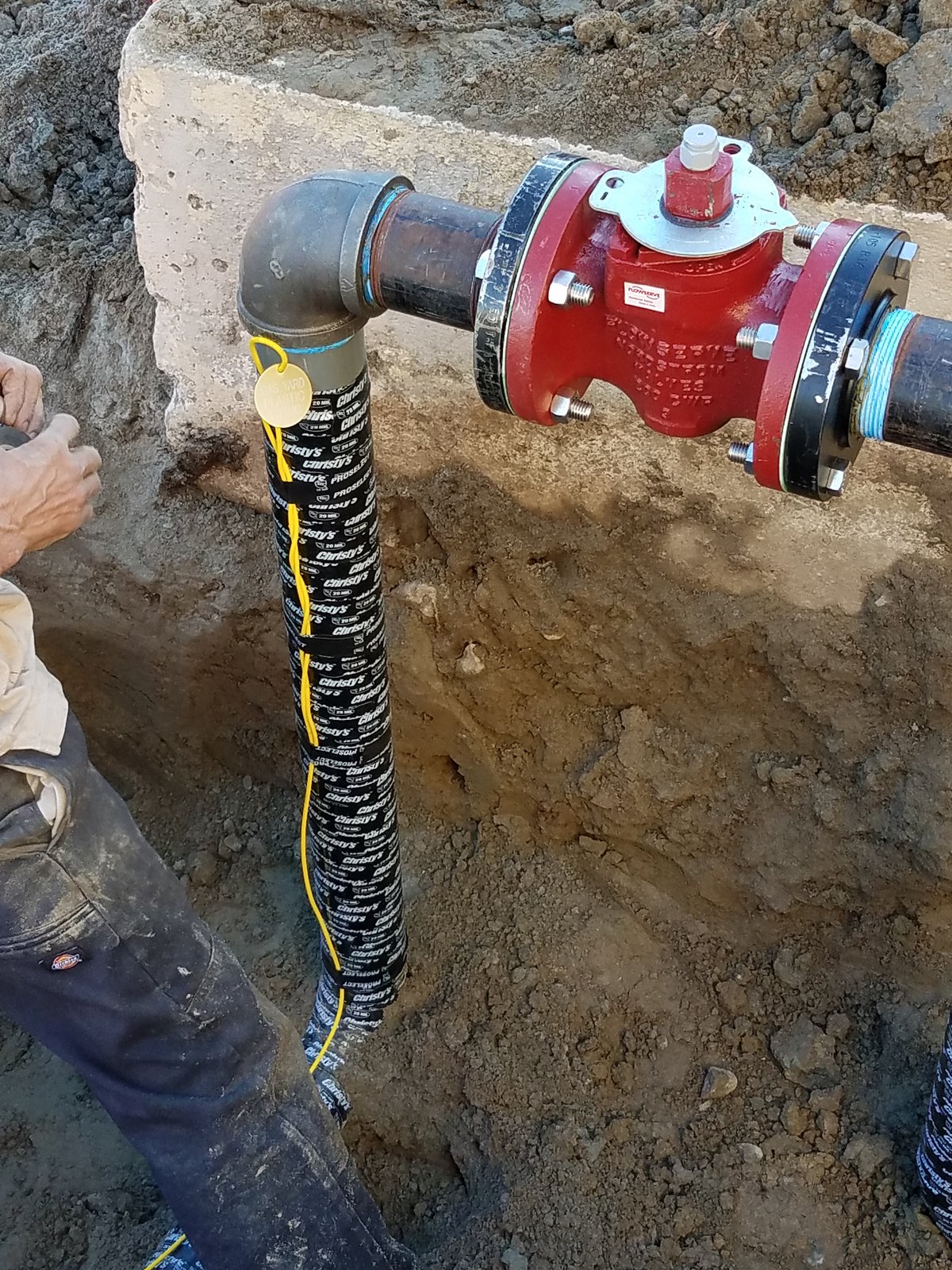 Technicians rerouting and replacing an underground natural gas line in an excavated trench in Orange County