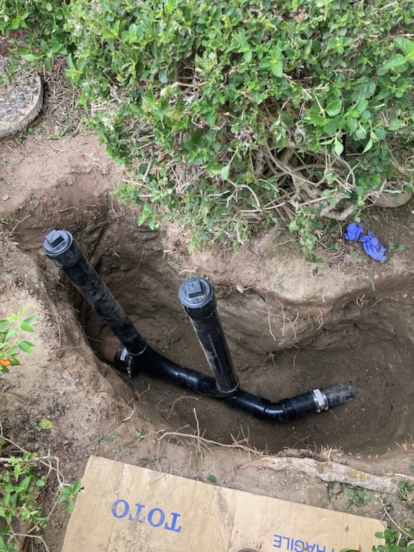 Orange County plumber installing a two-way sewer cleanout