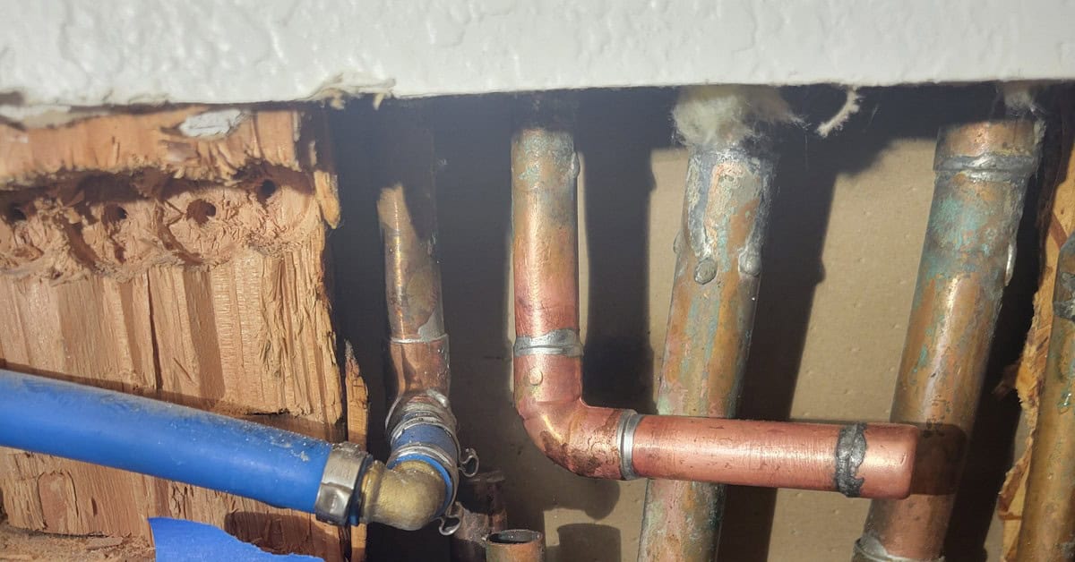 Corroded copper supplies exposed in a slab chase during a slab leak repair in Orange County
