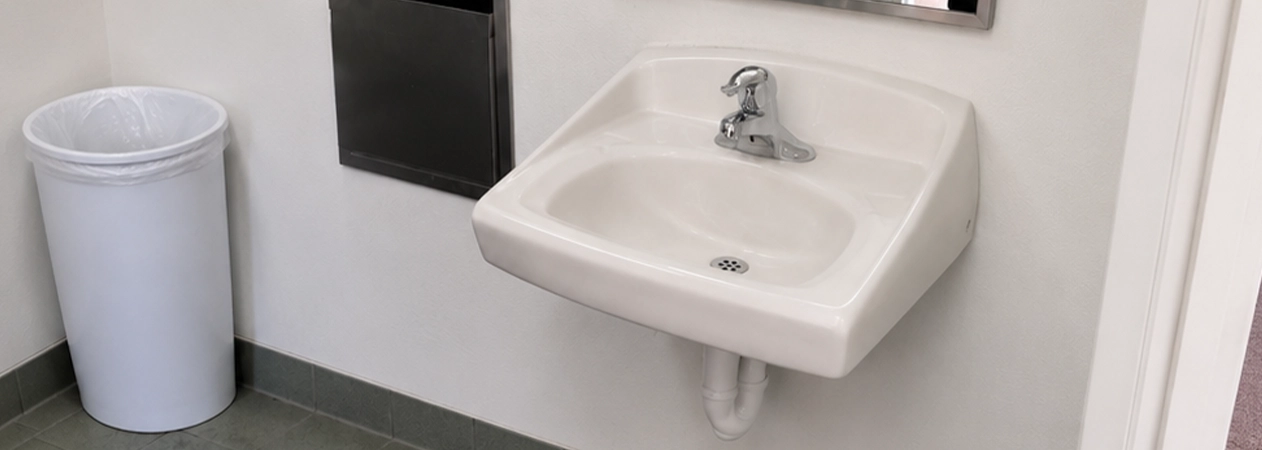 Costa Mesa commercial plumbing Costa Mesa commercial plumbing: servicing a high-traffic restroom flushometer.