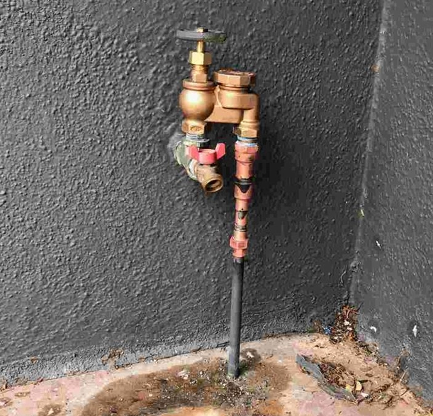 Manual pool-filler isolation valve and copper riser at an Orange County home Manual pool-filler isolation valve and copper riser at an Orange County home