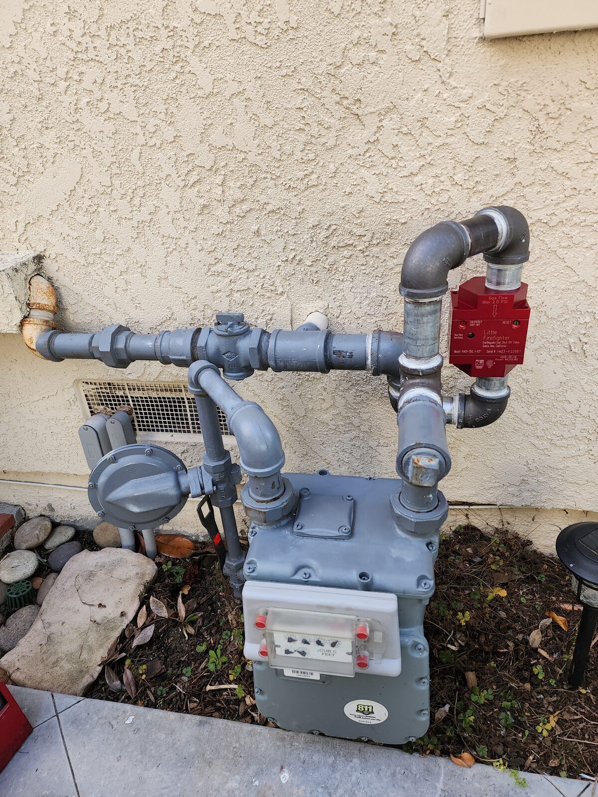 Earthquake gas shutoff valve offset install with piping rerouted around an existing gas shutoff at the meter