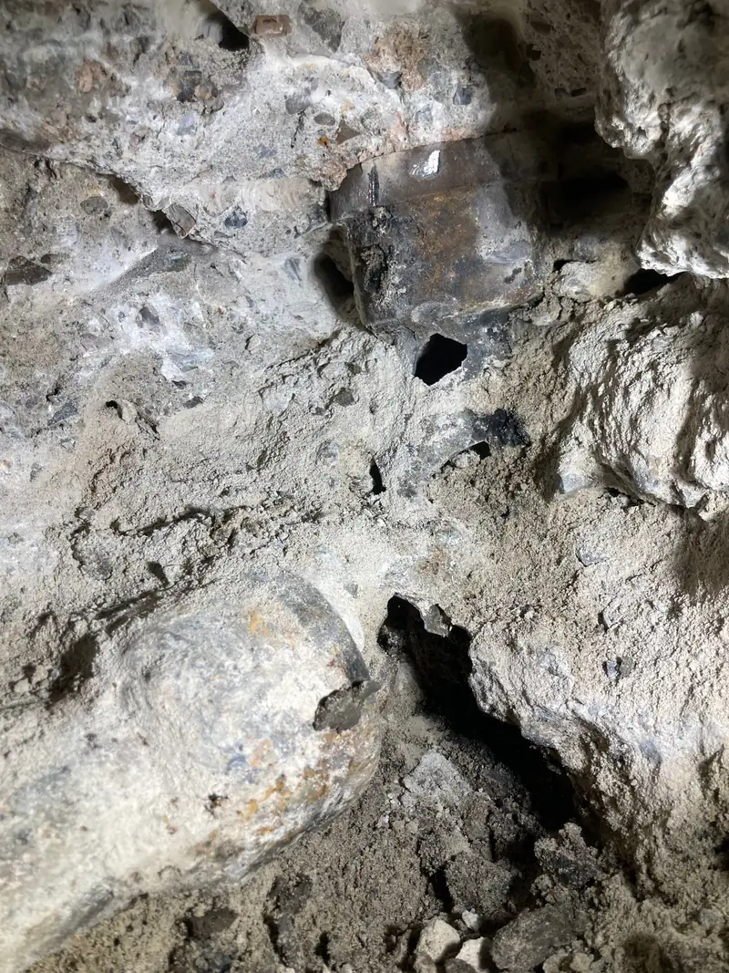 Corroded cast iron drain line broken open beneath a concrete slab on a Garden Grove sewer repair job
